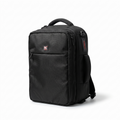 A black PK brand backpack with multiple zippered compartments, a top carry handle, and a side shoulder strap, photographed on a clean white background.